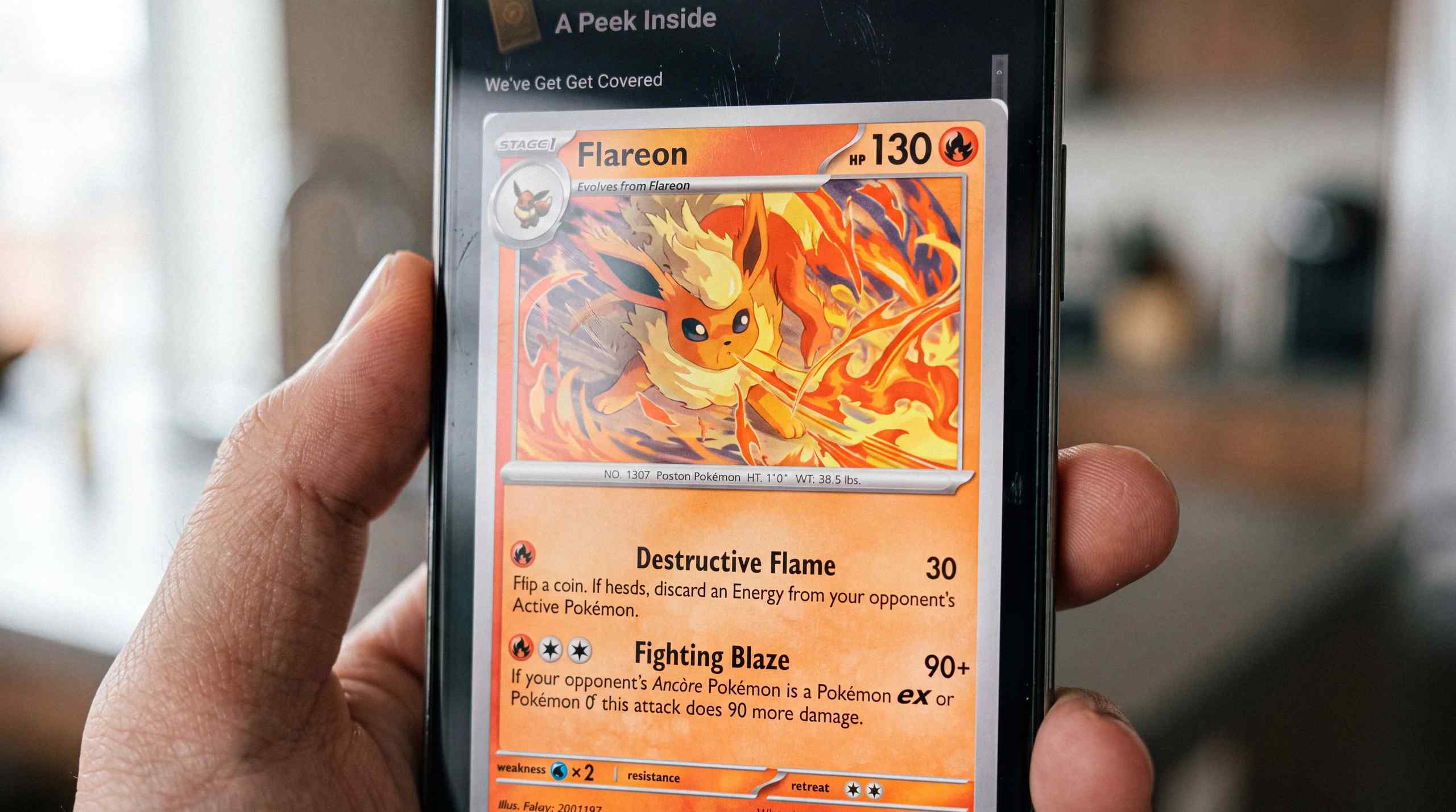 Someone pulling a Flareon Pokemon card on Crown Coins